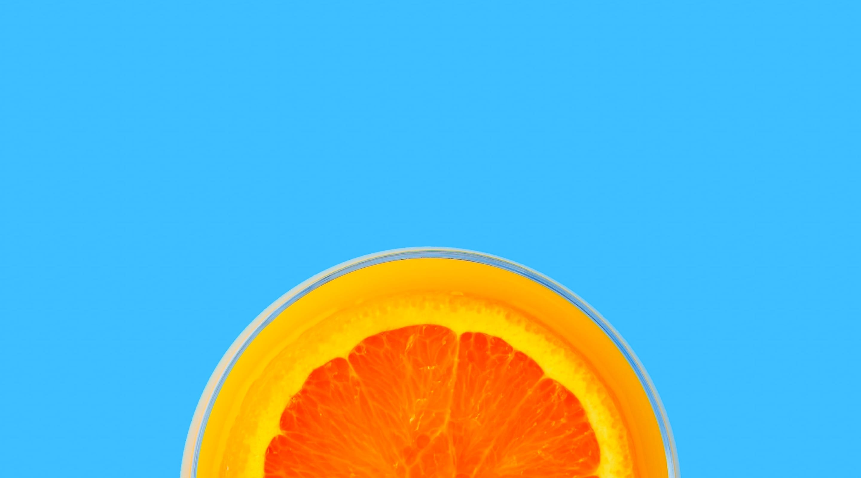 Orange halved against blue background